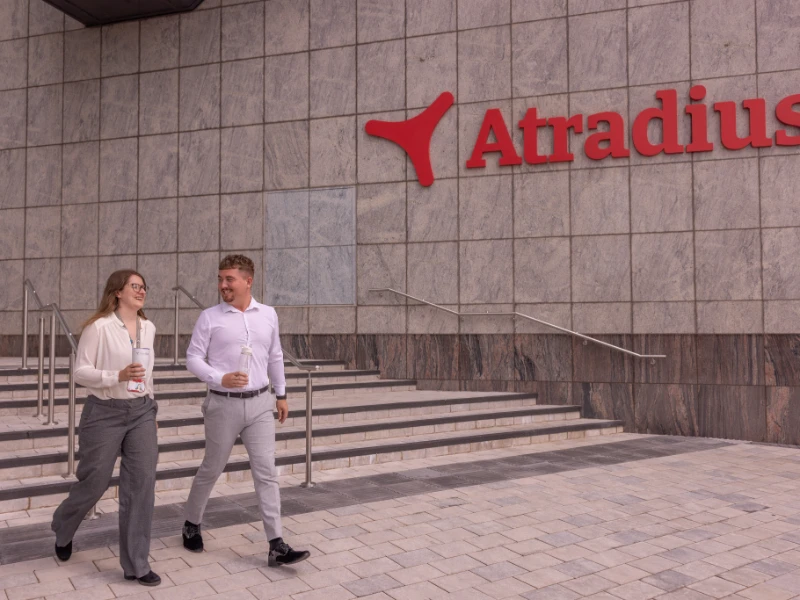 Woman and man going for a walk outside at the entrance of the Cardiff office