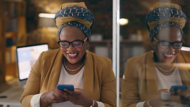Ethinic woman in a head dress using a mobile phone