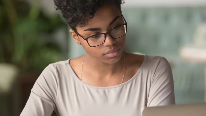 Woman studying data on a laptop