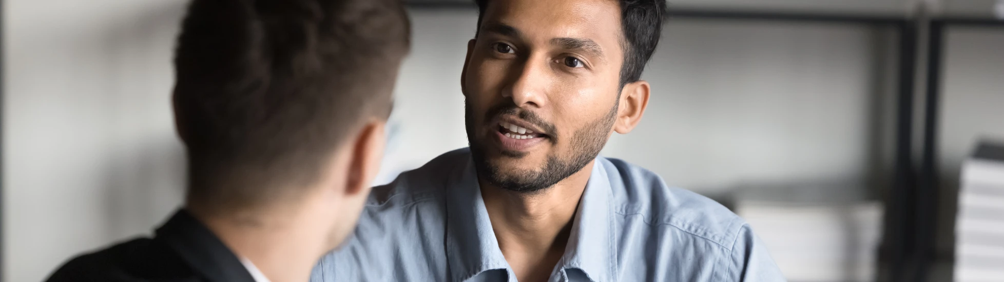 man talking with another man using hands