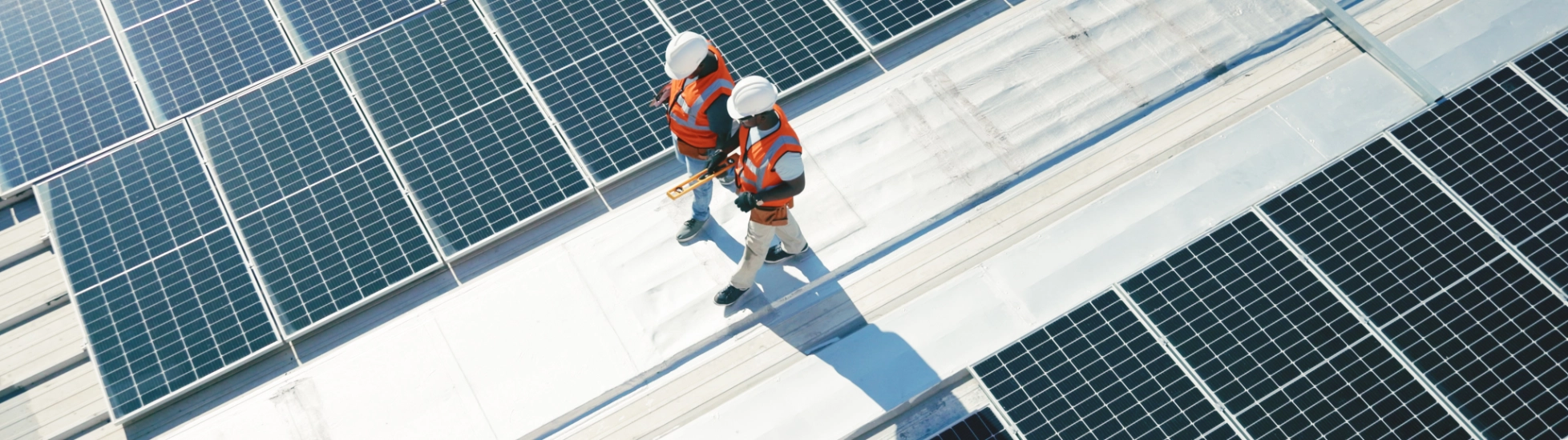 Two solar panel workers walking